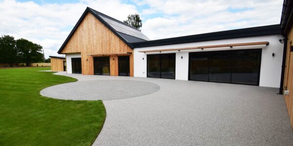 Modern single-storey disability adapted new build house with accessible driveway and garden