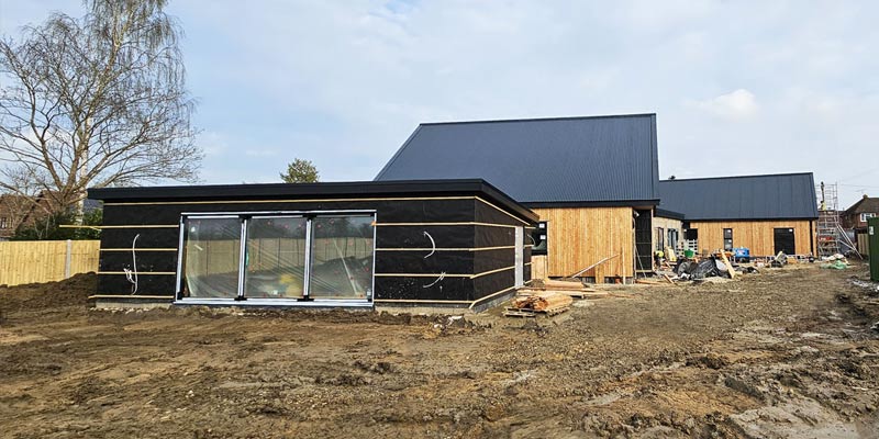 Accessible new build bungalow under construction on site in Kent. Main building and accessible outbuidings visible.
