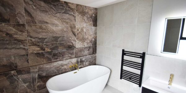 Modern luxury bathroom with marble tiles within bespoke inclusive and accessible home.