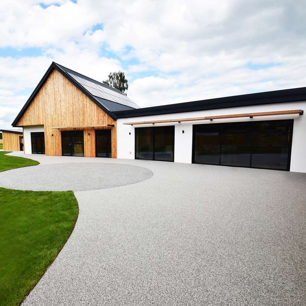 Modern adapted bungalow with accessible paths and curved driveway.