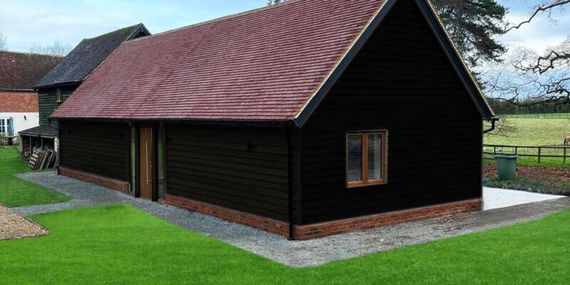 Accessible annexe in Canterbury, Kent. A single-storey, wheelchair-adapted annexe with black wood cladding to blend with heritage landscape.